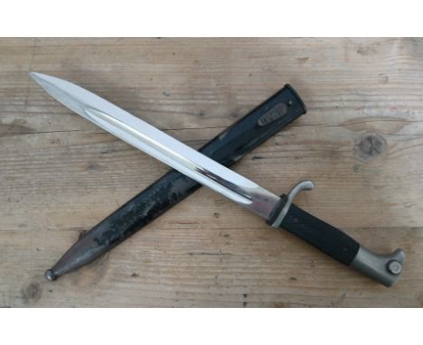 A German Third Reich K98 Parade bayonet, blade length 24.5cm, textured black bakelite grip, metal scabbard total length 40cm.