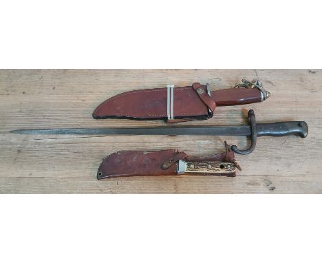 A French bayonet and two hunting knives. 