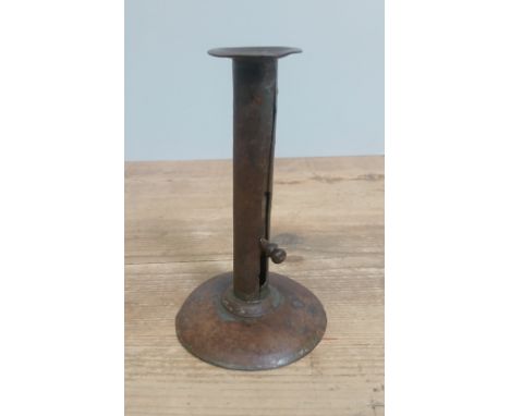 A hog scrapper candlestick height 17cm.