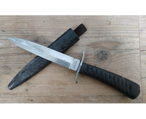 An Imperial German WWI fighting knife, the 13.5cm double edge steel blade signed 'UNION ZellaSt. Bl.', wooden grip, metal sca