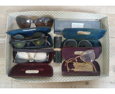 A tray of assorted vintage spectacles, sunglasses and a telescope.