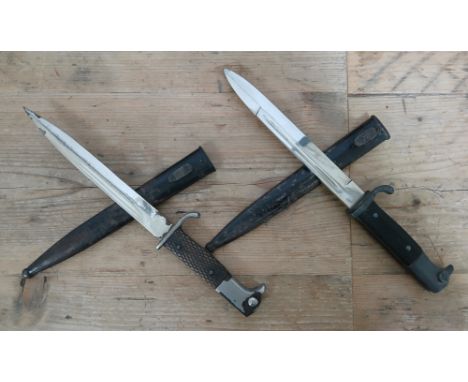 Two German Third Reich K98 Parade bayonets, one by Dolf Buchel, the other unmarked, blade length 19cm, textured black bakelit