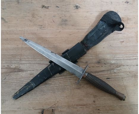 A British Commando Fairbairn Sykes FS fighting dagger, 3rd pattern, double edged blade unmarked, length 17cm, leather scabbar