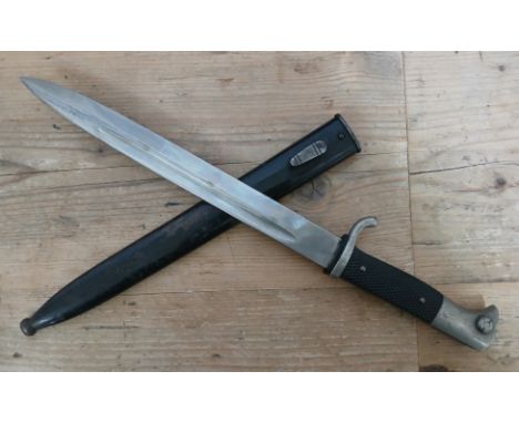 A German Third Reich K98 Parade bayonet by Puma, blade length 24.5cm, textured black bakelite grip, metal scabbard total leng
