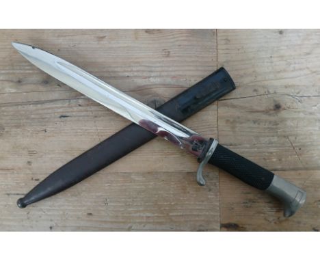 A German Third Reich K98 Parade bayonet by Carl Eickhorn, blade length 24.5cm, textured black bakelite grip, metal scabbard t