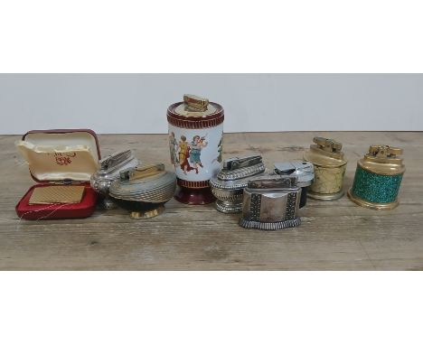 A tin of assorted vintage table lighters including a Ronson Diana, also including a Colibri gold plated lighter.