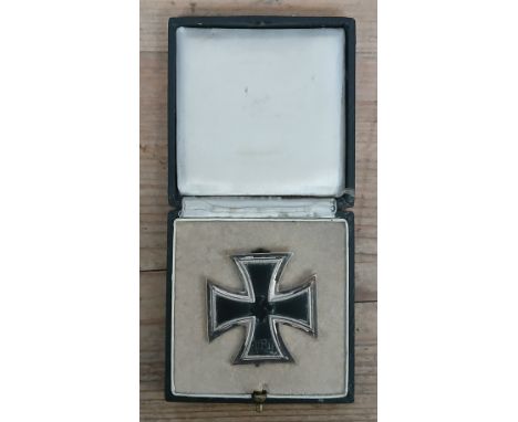 A German Third Reich WWII First Class Iron Cross with associated box.