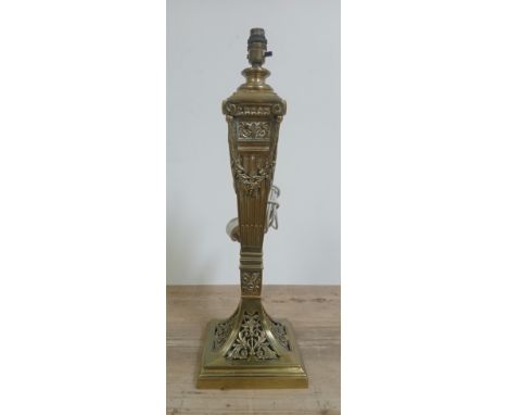 A Victorian weighted cast and pierced brass table lamp, height 56cm.