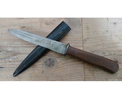 An Imperial German fighting or trench knife, 12.5cm single edged blade, wooden grip, metal scabbard, total length 27.5cm.