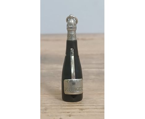 A Victorian white metal mounted horn novelty cigar cutter modelled as a Bollinger Champagne bottle, length 5.5cm.