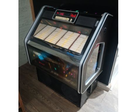 A 1983 Wurlitzer Fuego jukebox, appears in working order and complete with contents.