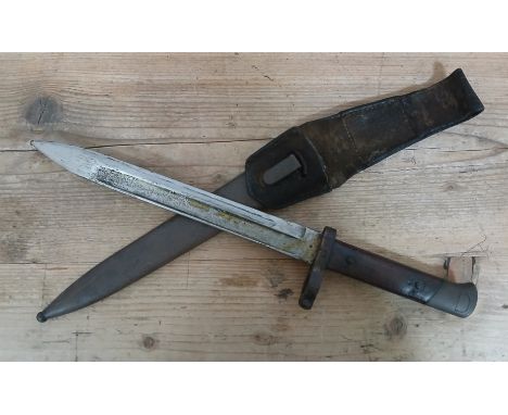 A WWI Austo-Hungarian bayonet, blade length 24cm, metal scabbard and leather frog, total length 39cm.