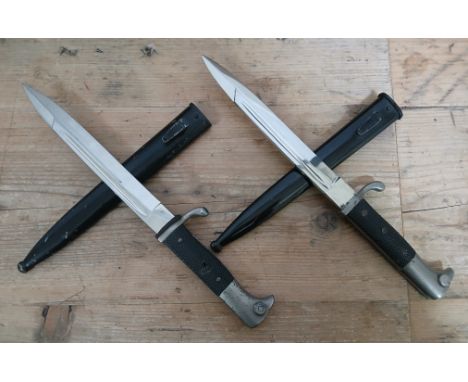 Two German Third Reich K98 Parade bayonets by Carl Eickhorn, blade length 19cm, textured black bakelite grip, metal scabbard,