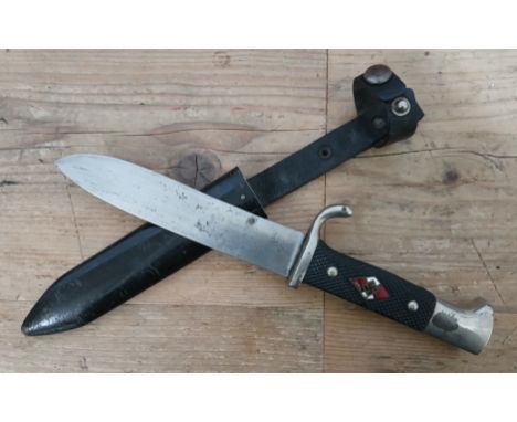 A German Third Reich Hitler Youth knife, the 13.5cm blade signed ASSO Solingen, textured black bakelite grip, metal scabbard 