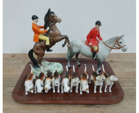 A Beswick hunting set comprising dappled grey horse and rider, rearing horse and rider and nine hounds.&nbsp;Condition - good