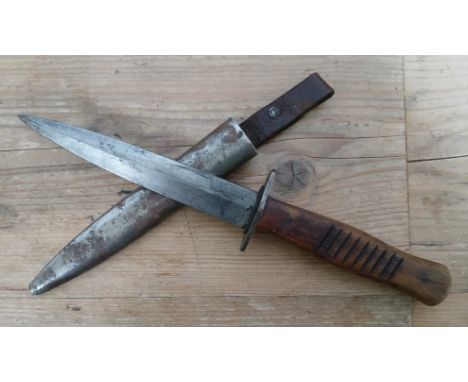An Imerpial German fighting knife, 14.5cm blade signed Hugo Holler Solingen, wooden grip, metal scabbard and leather hanger, 