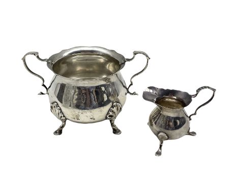 Edwardian silver circular sugar bowl with leaf capped handles Chester 1908 Maker Stokes and Ireland  and a silver cream jug B