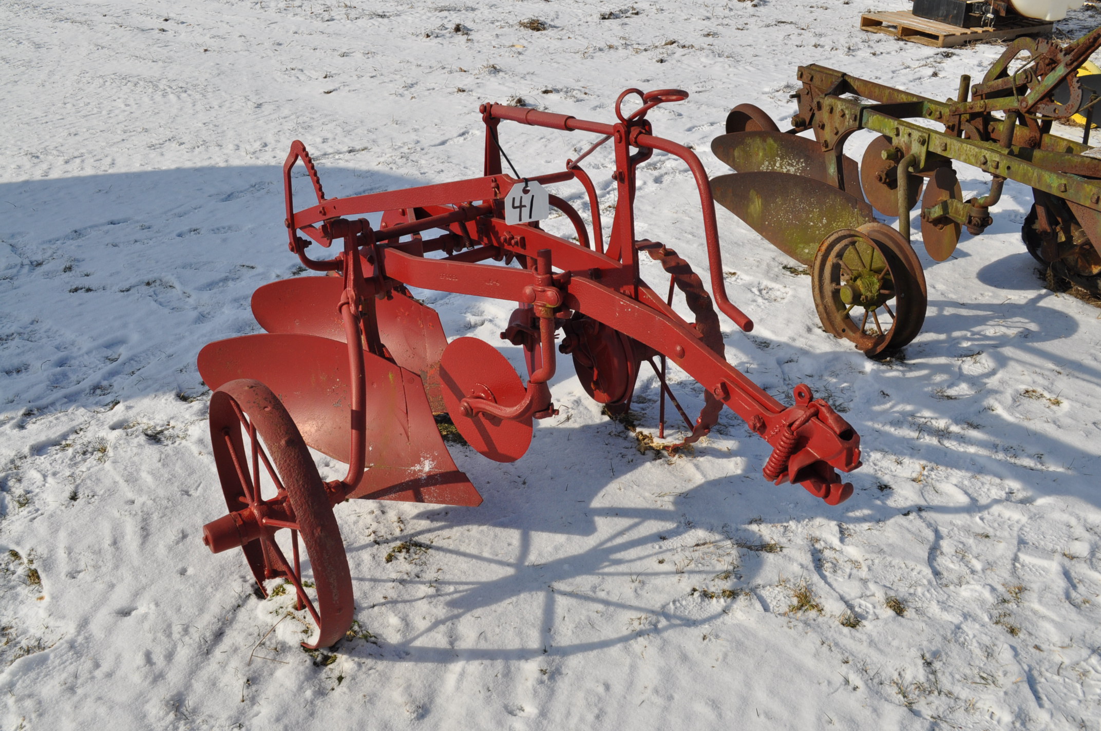 pull type moldboard plow, 2 bottom, steel wheels, painted red
