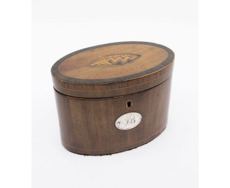 A George III oval mahogany tea caddy with shell inlay detail to the lid and a silver plaque with initials on the front