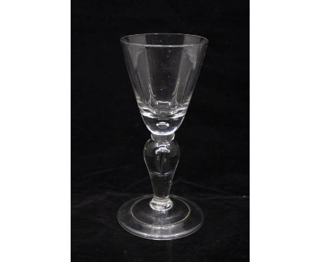 A Georgian baluster wine glass, circa 1725, round funnel bowl with an air tear in the base, an annular collar above an invert