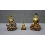 Three 20th century gilded copper Buddhist figures. One of Manjushri and the other two of Buddha.