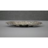 A Victorian pierced repousse design silver pin dish with floral and scrolling motifs and pierced