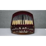 A early 20th century mahogany velvet lined cased part six person canteen of cutlery by various