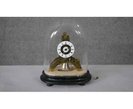 A small French brass skeleton clock with alarm, the white enamel chapter ring enclosing a central alarm dial on arched suppor