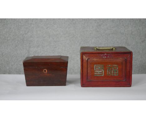 An early 19th century rosewood sarcophagus form tea caddy with fitted interior and a carved and brass bound cased Mahjong set