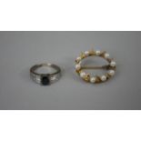 A 14 carat yellow gold and cultured pearl wreath brooch set with nine round cultured pearls, stamped