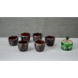 A collection of coloured glass. Including a set of six Manna gold foil ruby art glass cups, signed