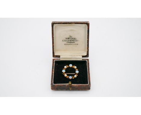 A 9 carat yellow gold opal and cultured pearl wreath brooch. The brooch is set with four round cabochon opals with a combined
