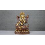 A large 20th century hand painted and gilded copper green Tara figure with hand painted details