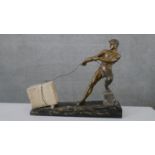 J. De Roncourt- An Art Deco cold painted spelter figure modelled and cast as a man hauling a block