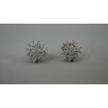 A pair of 9 carat white gold diamond stud cluster earrings with white metal butterflies. Each