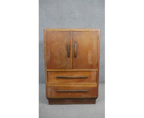 A mid century light oak Art Deco style tallboy cabinet. H.113 W.76 D.46cm 