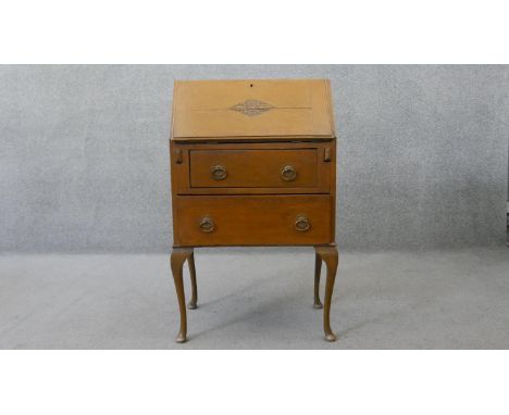 A mid century light oak carved bureau. H.100 W.61 D.38 cm 