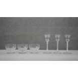 A collection of glasses. Including three Georgian air twist stem wine glasses with etched vine