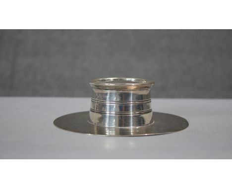 A Victorian circular silver lidded inkwell and quill holder. Inkwell has original glass liner. Hallmarked: GNWH for George Na