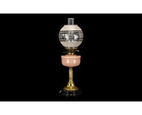 Victorian Oil Lamp with Pink Glass Font, Supported on a Brass Reeded Column on a Black Pottery Base, with Glass Dome and Funn