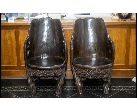 A Pair Of Impressive Carved Dugout Teak Tree Trunk Chairs, Profusely Carved With A Trunk, Branch And Foliage Design, Height 4