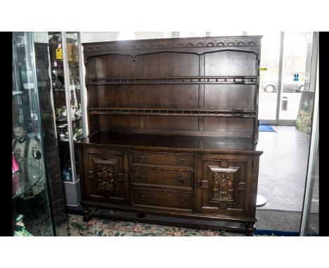 A Stained Oak Priory Dresser And Rack, Of Traditional Form, The Base With Two Cupboards And Three Central Drawers Above A Two