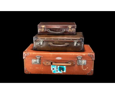 A Collection of Three Vintage Leather Suitcases comprising one tan case with Spartan plaque to front and two smaller dark bro