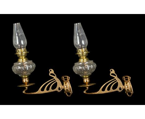 A Pair of Vintage Oil Lamps fitted to a candlestick wall bracket in brass. The glass font with a cut glass fluting. Measuring