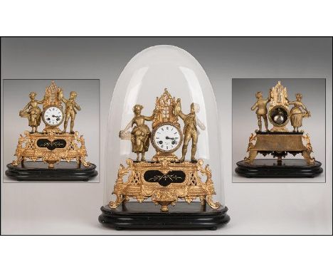 Antique French Gilt Metal Mantle Clock under a glass dome.  The central clock flanked by a loving couple offering fruits of t