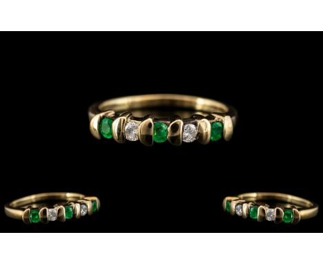 Ladies Contemporary and Attractive 9ct Yellow Gold, Diamond and Emerald Set Ring. Set with 3 Emeralds and Two Diamonds of Goo