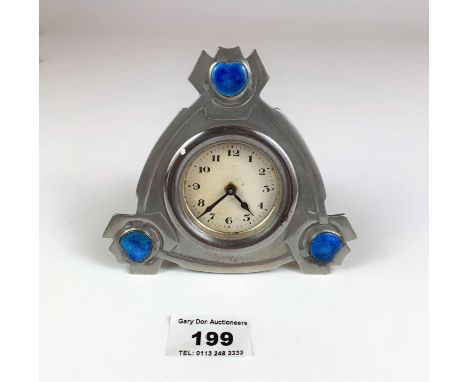 Small Tudric pewter desk clock designed by Archibold Knox, marked 01298, 4.5” high x 4.75” wide x 1.75” deep. Working