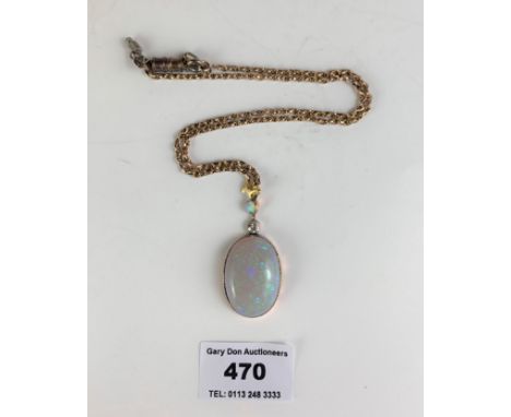 A diamond and white opal pendant ‘comprising a cabochon oval white opal, mounted within a millegrained yellow metal setting, 