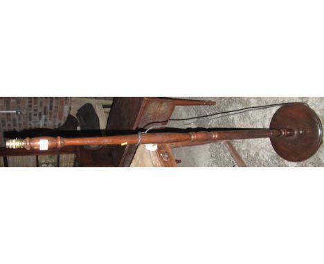 Modern mahogany standard lamp on circular base.