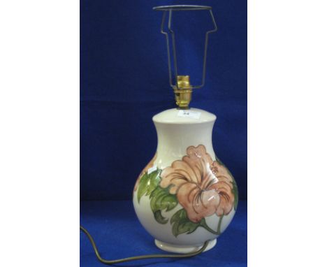 Moorcroft pottery floral table lamp on cream ground, green marks to base with lamp shade.